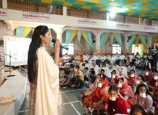 "Mamata Dhiraj Jain speaking at a community philanthropic outreach event"